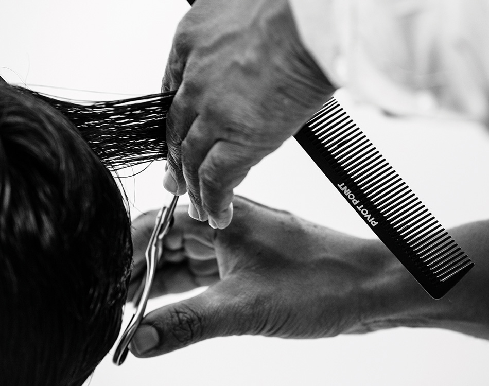 Stylist cutting client's hair