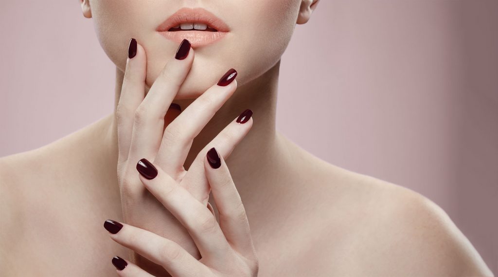 Close up with model nails in burgundy