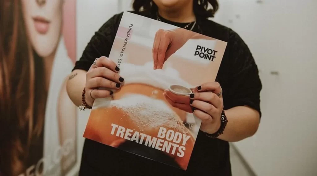 Pivot Point Esthetics Student Holding Book